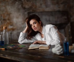 Girl leaning on the table and book on the desktop Stock Photo
