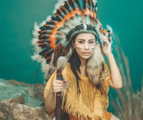 Girl soldier an Indian dress on head from feathers Stock Photo 01