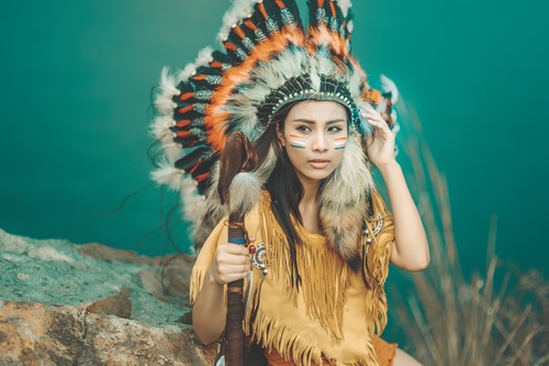 Girl soldier an Indian dress on head from feathers Stock Photo 01