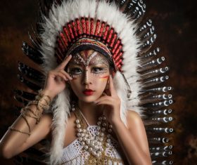 Girl soldier an Indian dress on head from feathers Stock Photo 02