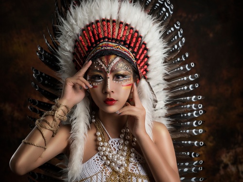 Girl soldier an Indian dress on head from feathers Stock Photo 02