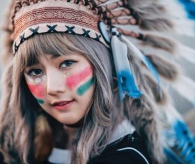 Girl soldier an Indian dress on head from feathers Stock Photo 03