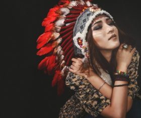 Girl soldier an Indian dress on head from feathers Stock Photo 05