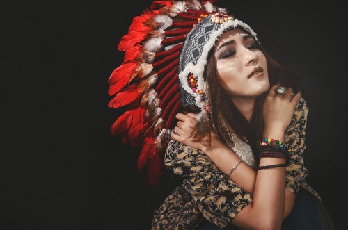 Girl soldier an Indian dress on head from feathers Stock Photo 05