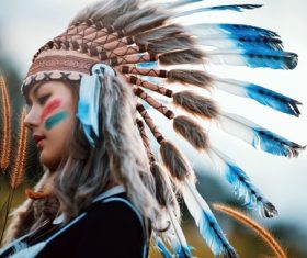 Girl soldier an Indian dress on head from feathers Stock Photo 06