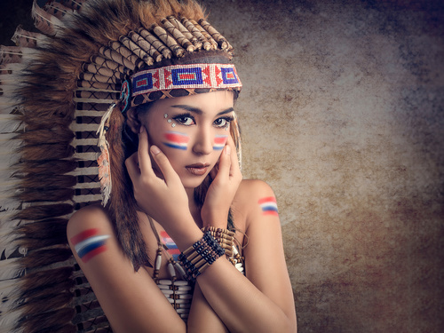 Girl soldier an Indian dress on head from feathers Stock Photo 07
