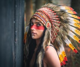Girl soldier an Indian dress on head from feathers Stock Photo 09