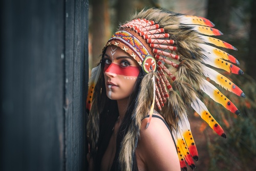 Girl soldier an Indian dress on head from feathers Stock Photo 09
