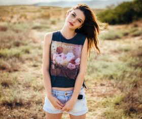 Girl wearing denim shorts and black T-shirt outdoors Stock Photo