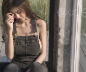 Girl wearing suspenders jeans Stock Photo