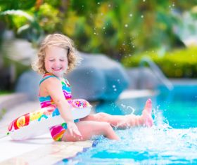 Happy children sitting by the pool Stock Photo