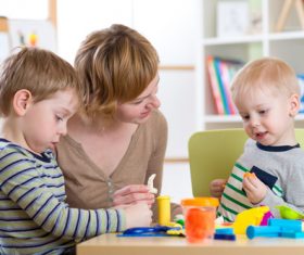 Kindergarten teacher and children Stock Photo