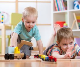 Little boy playing with toy car Stock Photo