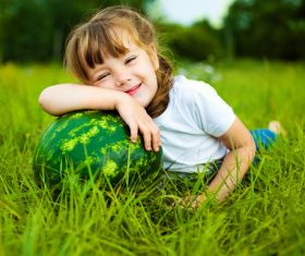 Little girl and watermelon on the grass Stock Photo