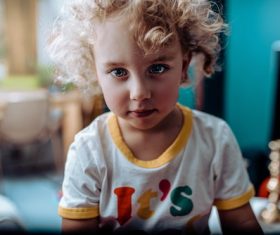Little girl with blond curly hair Stock Photo
