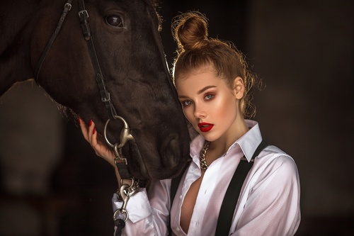 Makeup girl with black horse Stock Photo