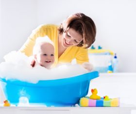 Mothers take care of bathing babies Stock Photo