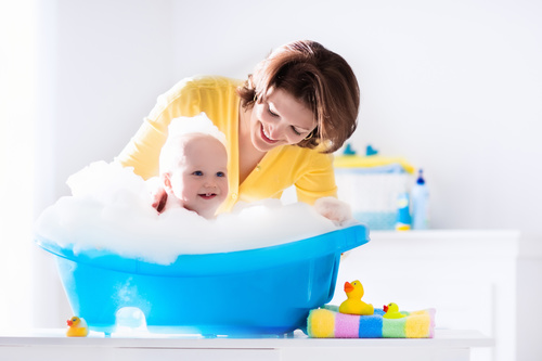 Mothers take care of bathing babies Stock Photo