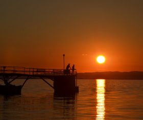 People fishing in the sunset Stock Photo