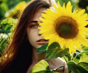 Pretty girl holding sun flower Stock Photo