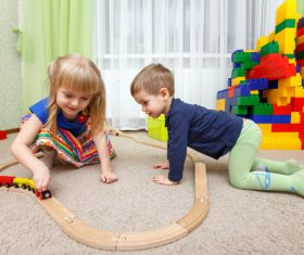 Sister and brother playing toy train Stock Photo