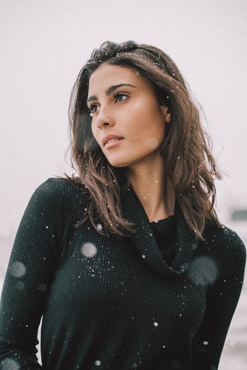 Snowflakes on woman outdoors Stock Photo
