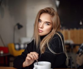 Stock Photo Woman elegant stirring coffee