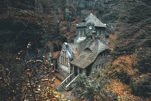 Stone house in the woods in the mountains Stock Photo