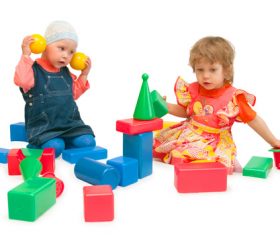 Two children playing with blocks Stock Photo