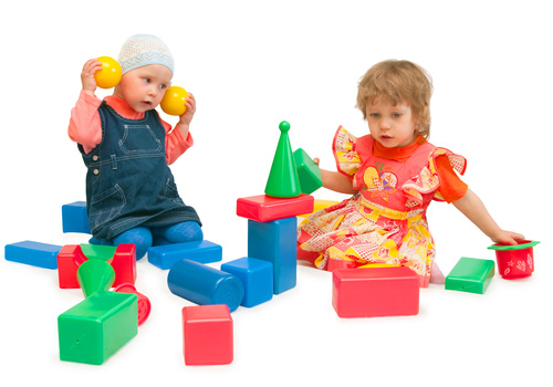 Two children playing with blocks Stock Photo