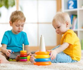 Two children playing with toys Stock Photo