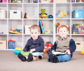 Two children reading comic books Stock Photo