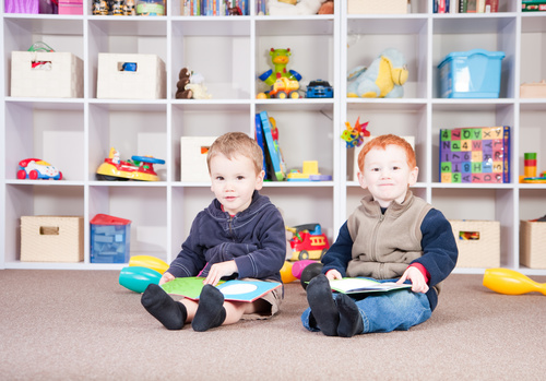 Two children reading comic books Stock Photo
