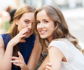 Two women whispering Stock Photo