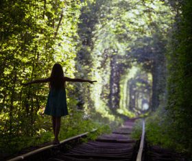 Walking on the rails girl Stretch hands Stock Photo
