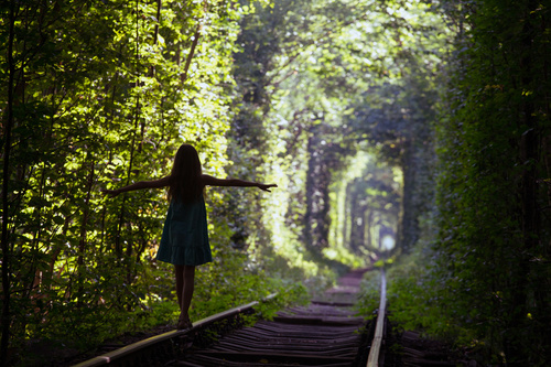 Walking on the rails girl Stretch hands Stock Photo