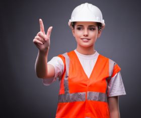 Wearing hard hat wearing overalls woman gesturing Stock Photo 01