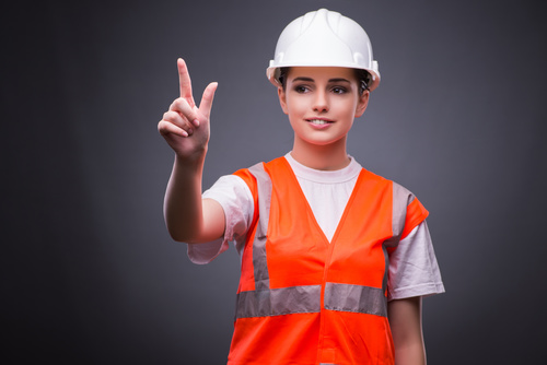 Wearing hard hat wearing overalls woman gesturing Stock Photo 01