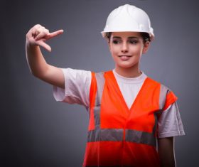Wearing hard hat wearing overalls woman gesturing Stock Photo 02