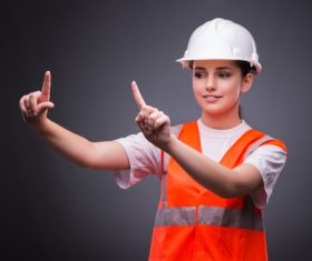 Wearing hard hat wearing overalls woman gesturing Stock Photo 03