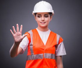 Wearing hard hat wearing overalls woman gesturing Stock Photo 05