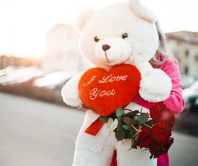 Woman Holding a Big Teddy Bear with I Love You Heart Stock Photo