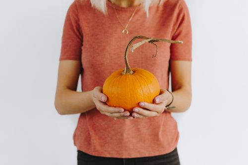 Woman holding a pumpkin Stock Photo