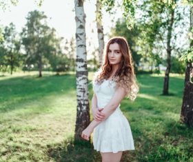 Woman in birch forest Stock Photo
