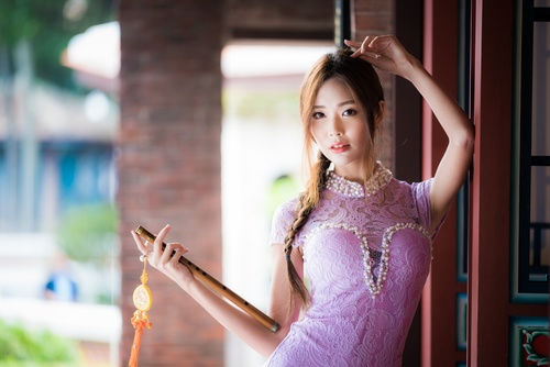 Woman in pink dress holding flute Stock Photo