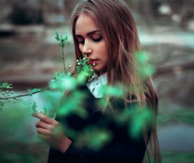 Woman looking at flower buds Stock Photo