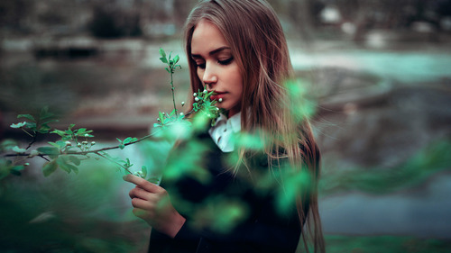 Woman looking at flower buds Stock Photo