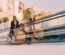 Woman on the escalator in the mall Stock Photo