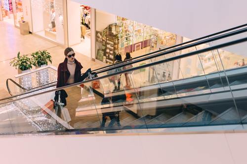 Woman on the escalator in the mall Stock Photo