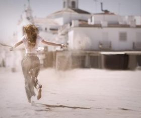 Woman running on the desert back shadow Stock Photo